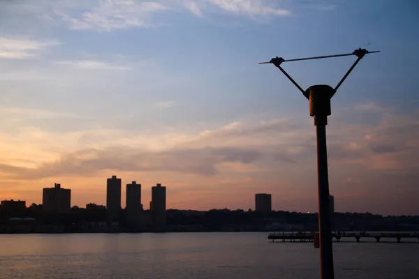 纽约市哈德逊河日落时与连接器相连的杆子 — 图库照片
