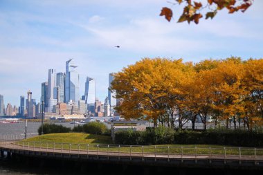 Hudson Metreleri Hoboken 'den bir sonbahar günü ağaçlar ve Hudson nehri arasında yeşilliklerle