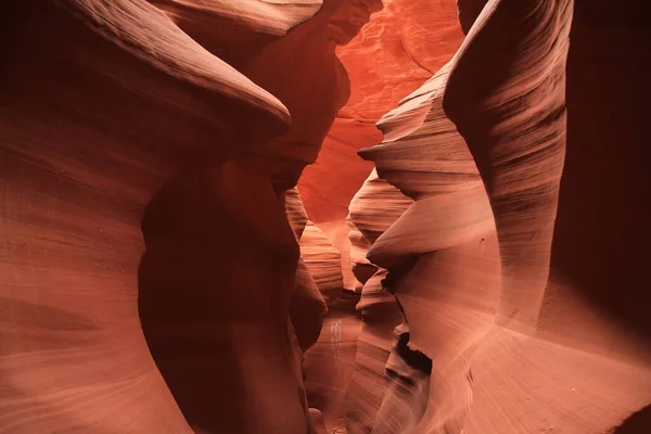 The narrow path surrounded by red walls in the Antelope Canyon in Arizona
