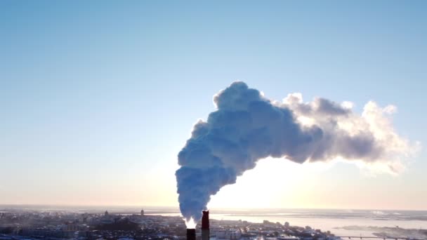 Chimneys of a factory or power plant produce smoke at sunrise, aerial view from a drone. The concept of ecological air pollution, environment, climate change, global warming, 4k video — Stock Video