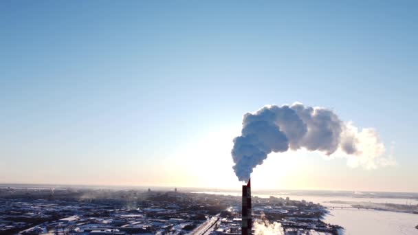 Chimneys of a factory or power plant produce smoke at sunrise, aerial view from a drone. The concept of ecological air pollution, environment, climate change, global warming, 4k video — Stock Video