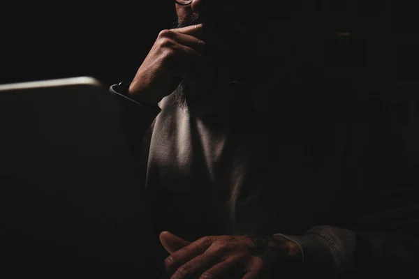 Anonymous man at a laptop at night. Internet addiction concept