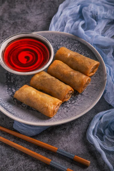 Close up of Vietnamese spring rolls with sweet sauce. portrait image