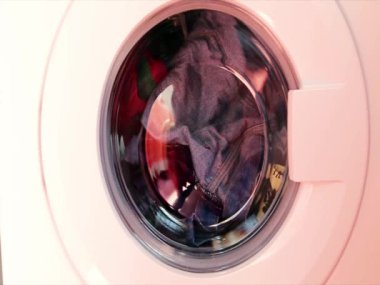 Washing machine washes colored clothes. Cylinder rotation. No one