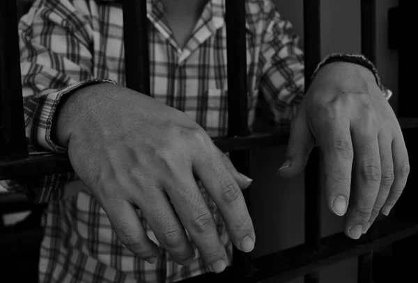 Hands on jail bar — Stock Photo, Image