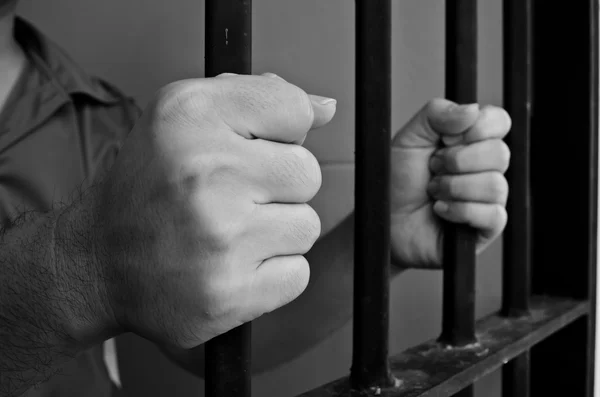Hands on jail bar — Stock Photo, Image