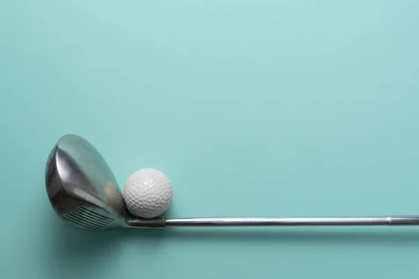 golf ball and golf club on green table background, flat lay,  sport concept