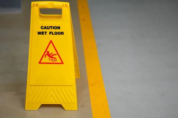 Warning sign for wet floor in the factory office