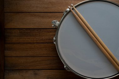 Bateri çubuğu ve davul ahşap masa arkaplanı, üst görünüm, müzik konsepti