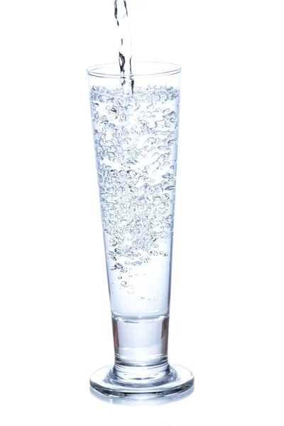 Water pouring in a glass on white background. — Stock Photo, Image