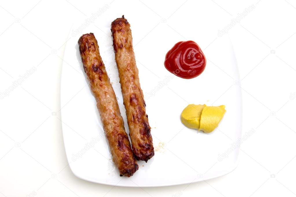 Sausage with ketchup and mustard on as seen from above