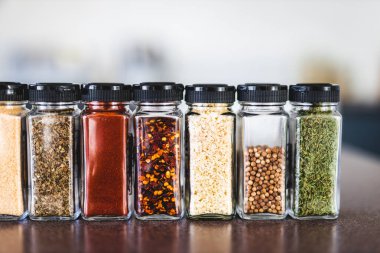 Baharat tohumları ve baharatlar düzenli kiler rafındaki baharat kavanozları, basit vejetaryen malzemeleri ve yemeklerinizin lezzeti.