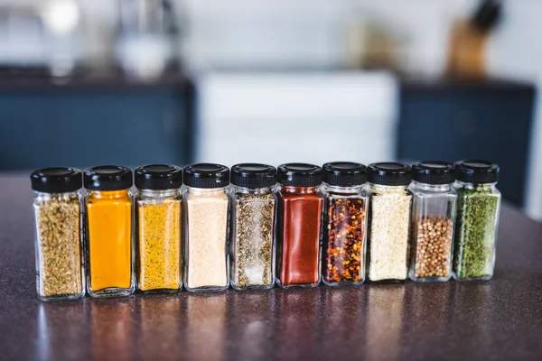 spices seeds and seasonings in matching spice jars on tidy pantry shelf, simple vegan ingredients and concept of flavoring your dishes