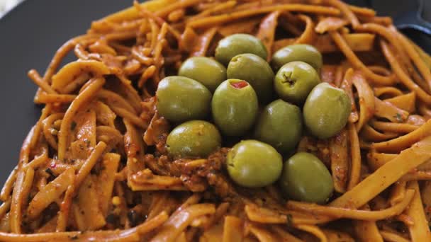 Espagueti Pesto Rojo Vegano Fettuccini Mezcla Con Aceitunas Verdes Cubierta — Vídeos de Stock