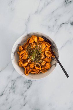 Ev yapımı kremalı tofu ve dolma biber soslu vejetaryen kabuklu makarna, sağlıklı bitki temelli yemek tarifleri.