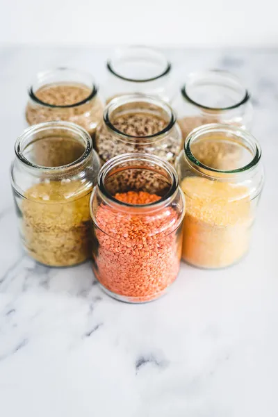 Healthy Whole Grains Legumes Clear Pantry Jars Marble Background Including — Stock Photo, Image