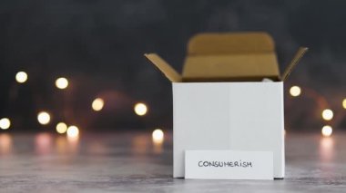 Tüketim kavramsal görüntüsü, arka planda parlak peri ışıkları ve metin ile satın alınan mallar için teslimat paketleri