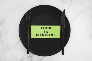 Yemek, çatal ve bıçakla yemek tabağındaki tıbbi metindir. Diyet, sağlıklı beslenme ve sezgisel yemek kavramı.