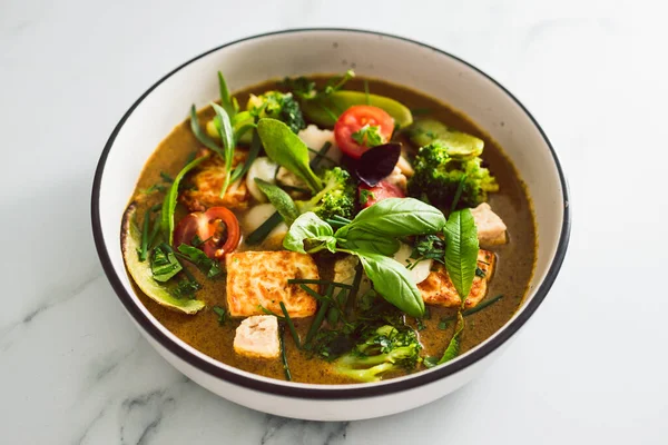 Kızarmış ipek tofu brokoliyle vegan Thai yeşil körisi ve bahçeden taze toplanmış bezelyeler, sağlıklı bitki temelli yemek tarifleri.