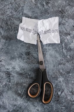 Kırışmış kağıt parçasındaki manipülasyon metni toksik davranışlarla başa çıkmak için makasla, psikoloji konseptiyle ve duygusal güçle kesiliyor.