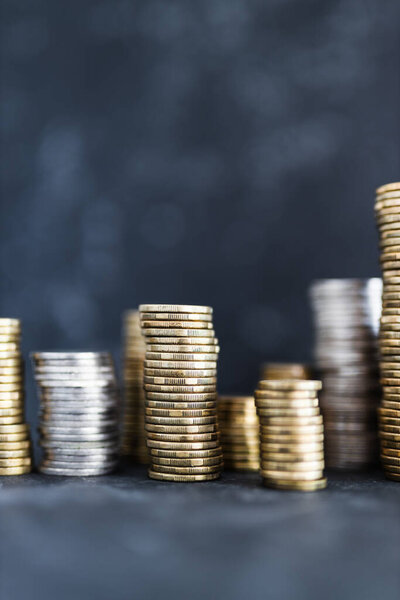 stacks of different golden and silver coins creating a big amount of savings, concept of abundance and wealth