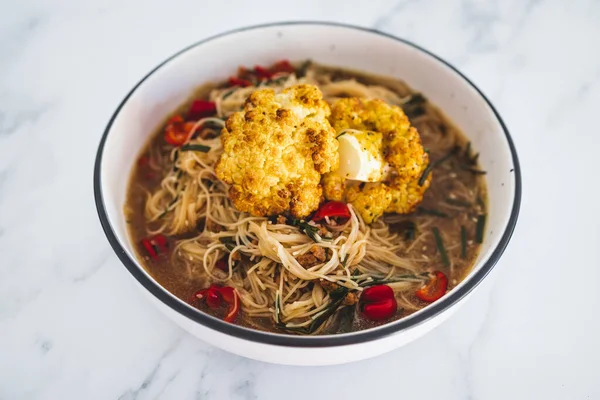 vegan vermicelli noodle soup with roasted cauliflower and bell peppers, healthy plant-based food recipes