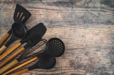 Eşleşen ahşap ve silikon mutfak aletleri, evde yemek pişirme ya da yemek pişirmeyi öğrenme kavramı.