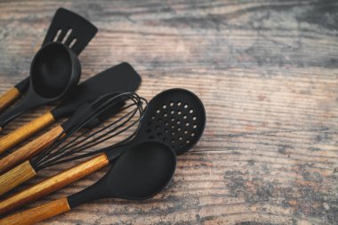 Eşleşen ahşap ve silikon mutfak aletleri, evde yemek pişirme ya da yemek pişirmeyi öğrenme kavramı.