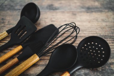 Eşleşen ahşap ve silikon mutfak aletleri, evde yemek pişirme ya da yemek pişirmeyi öğrenme kavramı.