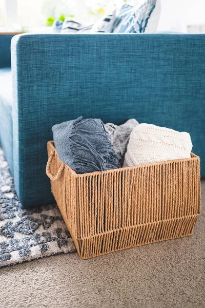 winter lifestyle and cosy home decor concept, soft and fluffy blankets and throws in rattan basket