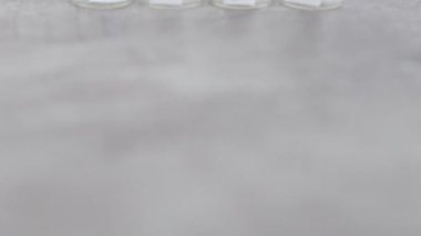 small apothecary style bottles with ingredients labels, concept of natural beauty and organic ingredients in skincare