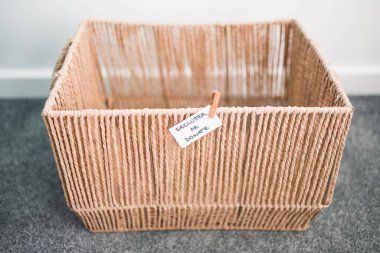 storage basket with Declutter or Donate label on it and nothing inside of it, concept of decluttering and tidying up around your home clipart