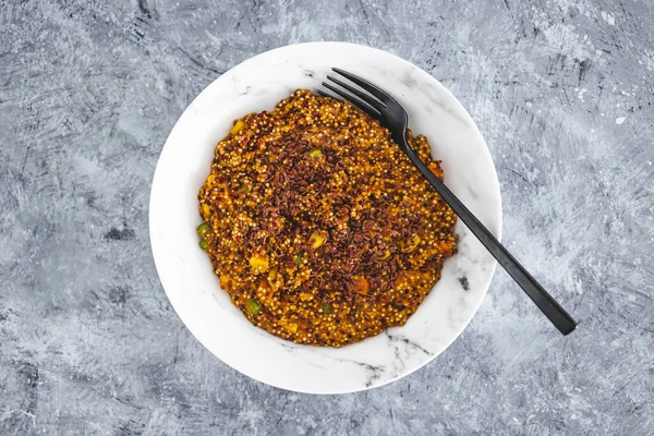 vegan quinoa with corn peas and carrots wit red pesto and flaxseeds topping, healthy plant-based food recipes