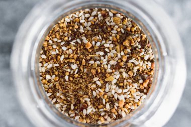 spice jar with dukkah seasoning close-up shot of pantry ingredients, concept of simple toppings to flavour your dishes