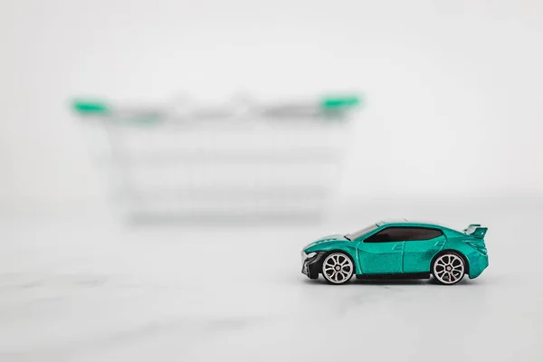 Toy Car Shopping Basket White Marble Background Concept Buying New — Stock Photo, Image