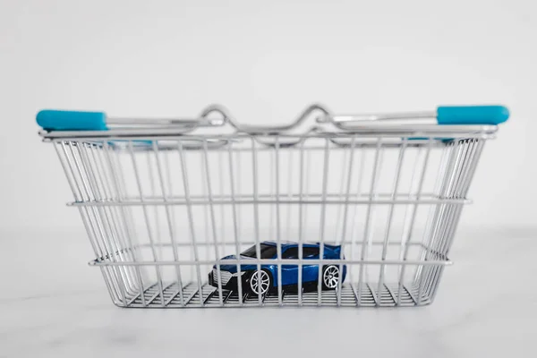 Toy Car Shopping Basket White Marble Background Concept Buying New — стоковое фото