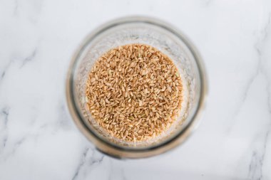 Kilerde kahverengi pirinç kavanozu, yukarıdan aşağıya doğru yakın plan olarak çekilmiş, basit malzeme kavramı. 