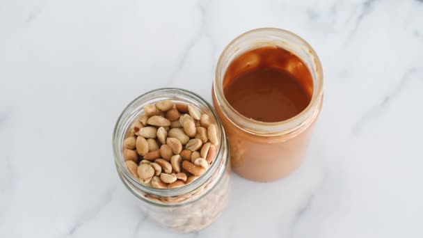 Glass Jars Peanuts Peanut Butter White Marble Background Natural Healthy — Video Stock