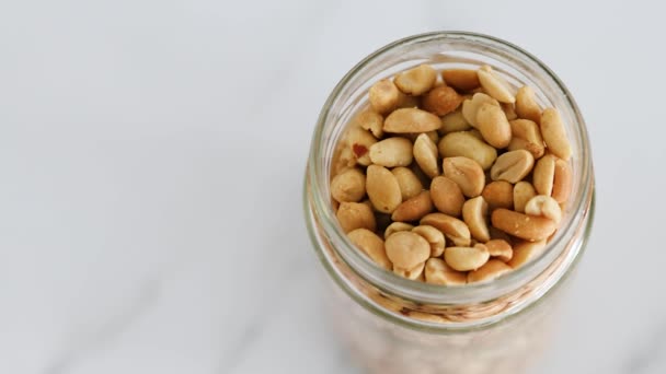 Glass Jar Peanuts White Marble Background Natural Healthy Pantry Staple — Stock video