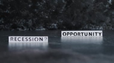 recession or opportunity texts over dark background with focus switching between the two