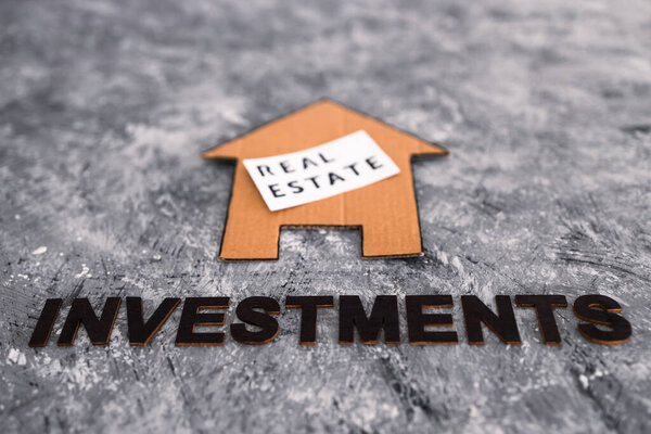 investment opportunities and building wealth conceptual image, real estate house icon with text underneath