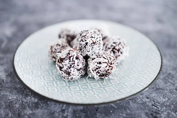 plant-based chocolate and nut butter bliss balls with coconut topping, healthy vegan food recipes