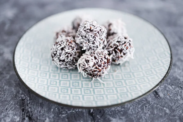 plant-based chocolate and nut butter bliss balls with coconut topping, healthy vegan food recipes