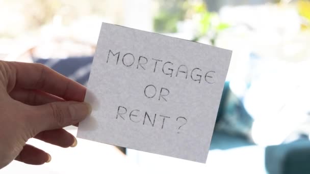 Hand Holding Mortgage Rent Sign Front Living Room Bokeh Concept — Stok Video