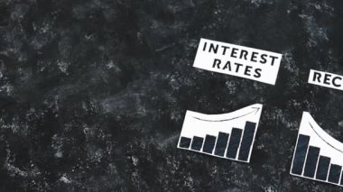 interest rates and recession texts and graphs showing cost of financing going up and economic growth going down, concept of the global economy after the covid-19 pandemic