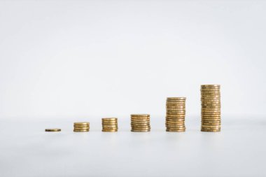 growing stacks of coins representing increasingly expensive prices or savings and compound interests increasing, finance and money conceptual image