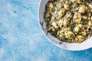 plant-based pesto and spinach gnocchi with pine nuts, healthy vegan food recipes