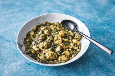 plant-based pesto and spinach gnocchi with pine nuts, healthy vegan food recipes