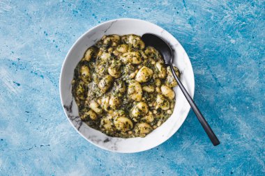 plant-based pesto and spinach gnocchi with pine nuts, healthy vegan food recipes