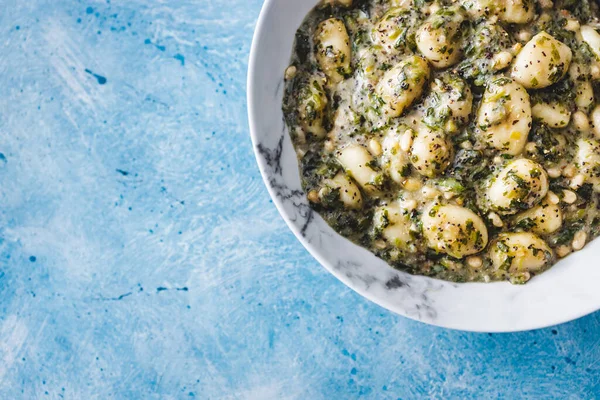 plant-based pesto and spinach gnocchi with pine nuts, healthy vegan food recipes